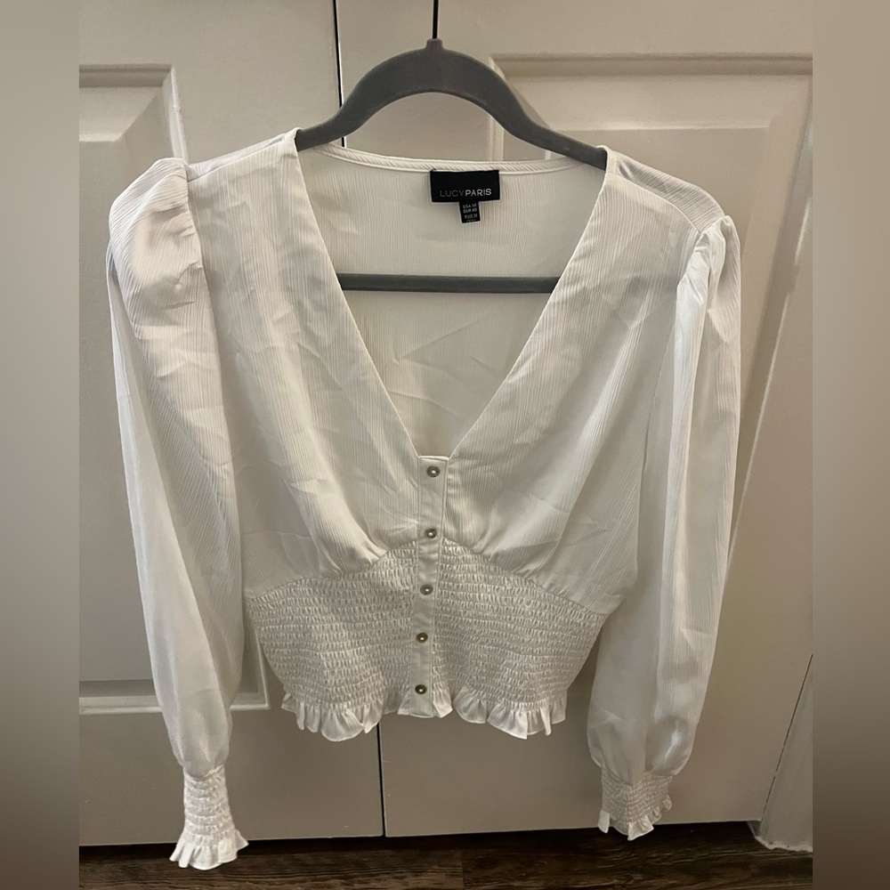 Women’s top with cinched sleeves and around stomach